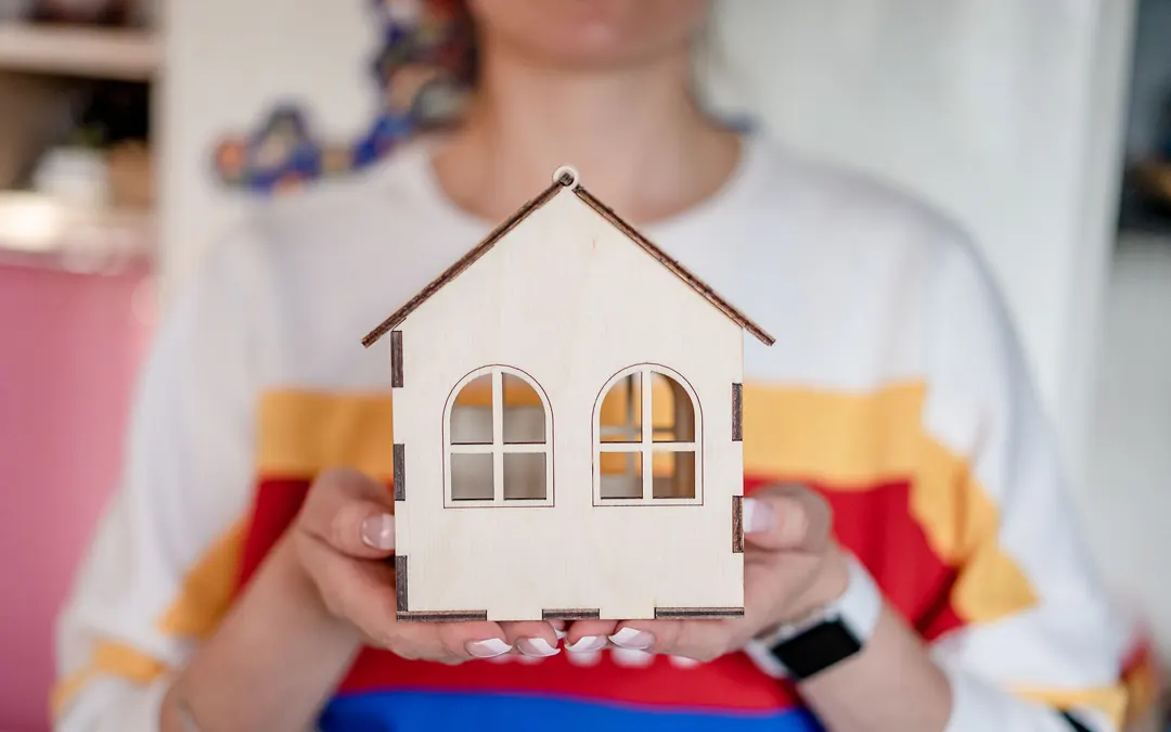 Appraisal woman holding model house