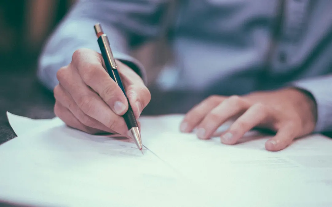 Private Mortgage Insurance (PMI) man writing in notebook at desk